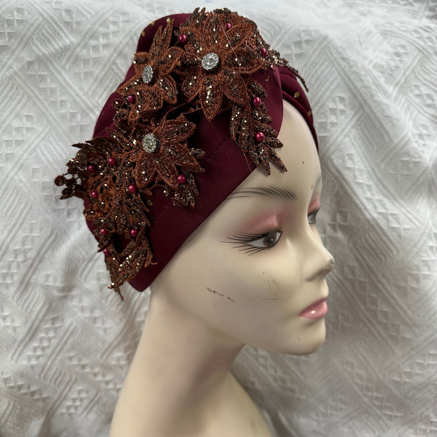 Elegant fashion headwear, gele turban flower design.
