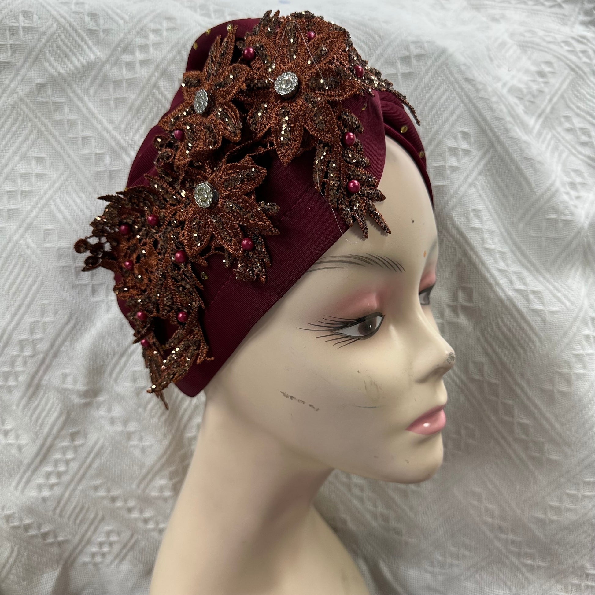 Elegant fashion headwear, gele turban flower design.